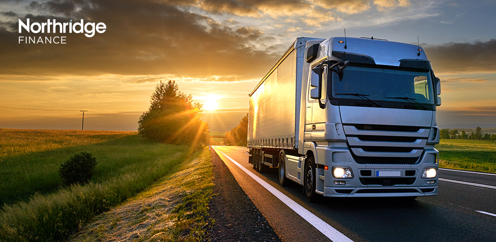 Image of a lorry on a road at sunset